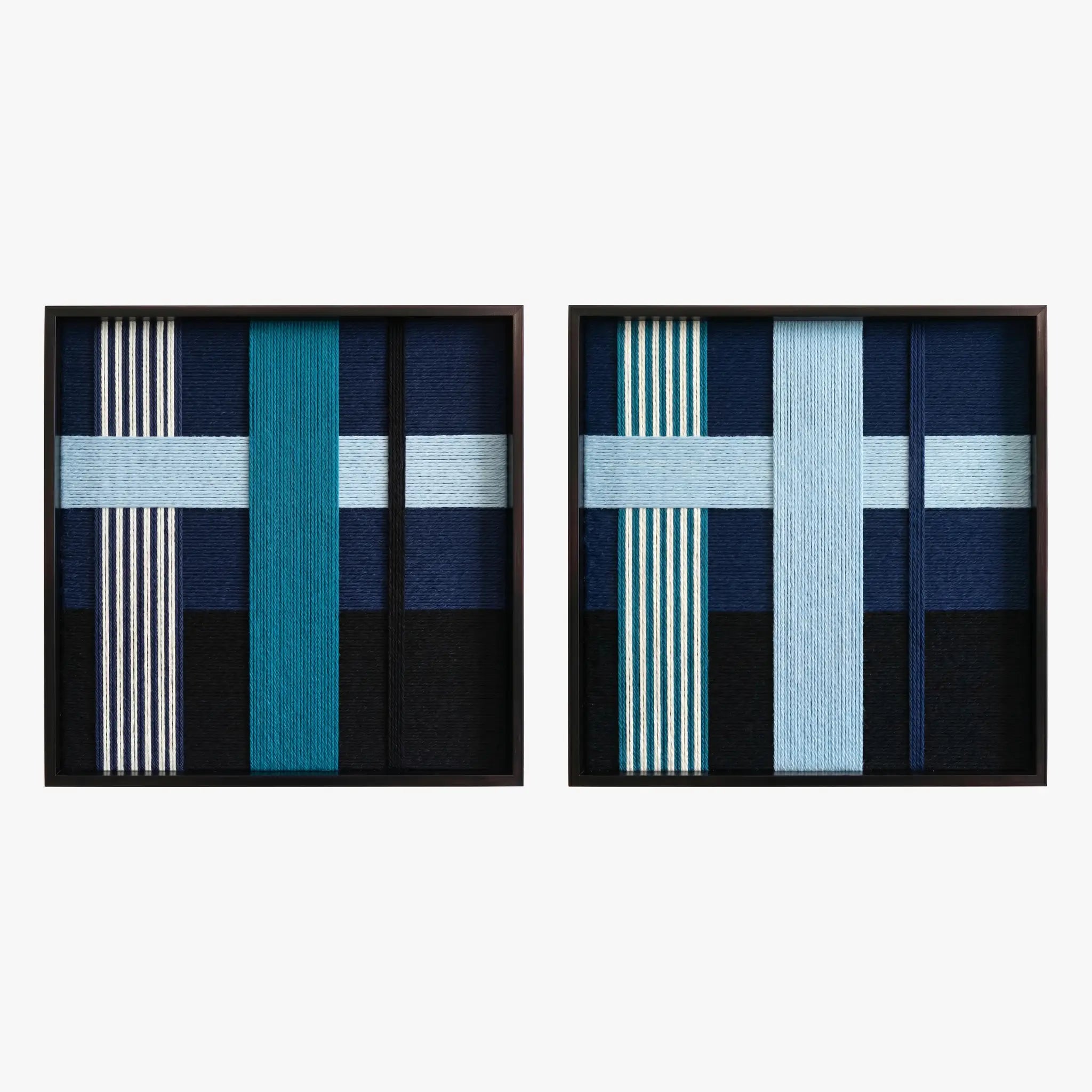 Frontal studio shot of the Glacial Stationeries textile art pair, showcasing two matching square hand-woven wall art pieces with icy blue and navy geometric designs in black frames.