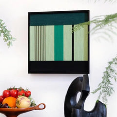 Close-up of Green Branches wall art revealing the looped wool texture and crisp transitions between emerald and mint panels.
