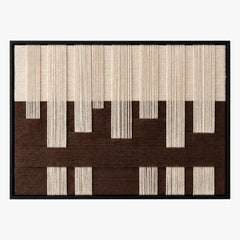 Frontal studio shot of the Ivory Loom hand-woven wool wall art featuring brown and cream geometric patterns.