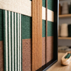 Macro side view of the Jade Manor tapestry highlighting the three-dimensional depth and structural layering of the hand-wrapped wool yarn.