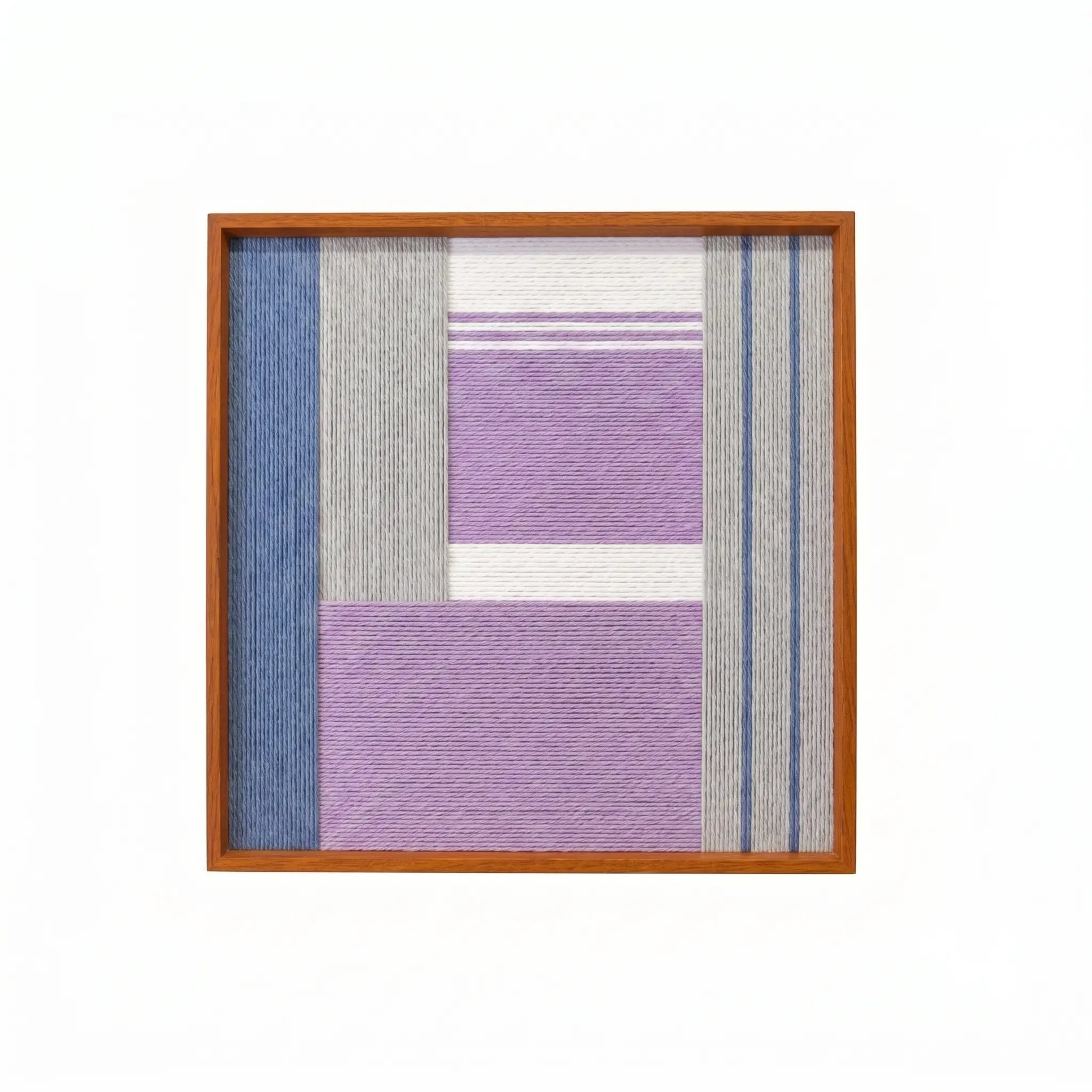 Professional studio shot of the Material Mass hand-woven wool wall art in a square wooden frame against a white background.