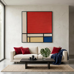 De Stijl inspired hand-woven wool tapestry displayed above a white modern sofa with red accent pillows and a black coffee table.