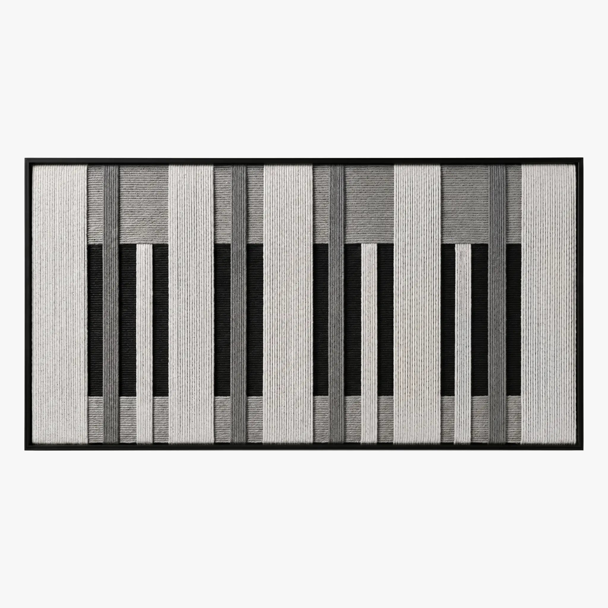 Frontal studio shot of the Monochrome Tempo hand-woven wool tapestry featuring a black, white, and grey piano key geometric pattern in a black frame.