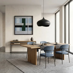 Modern hand-woven wool tapestry styled in a contemporary dining room with a large wooden table and blue upholstered chairs.