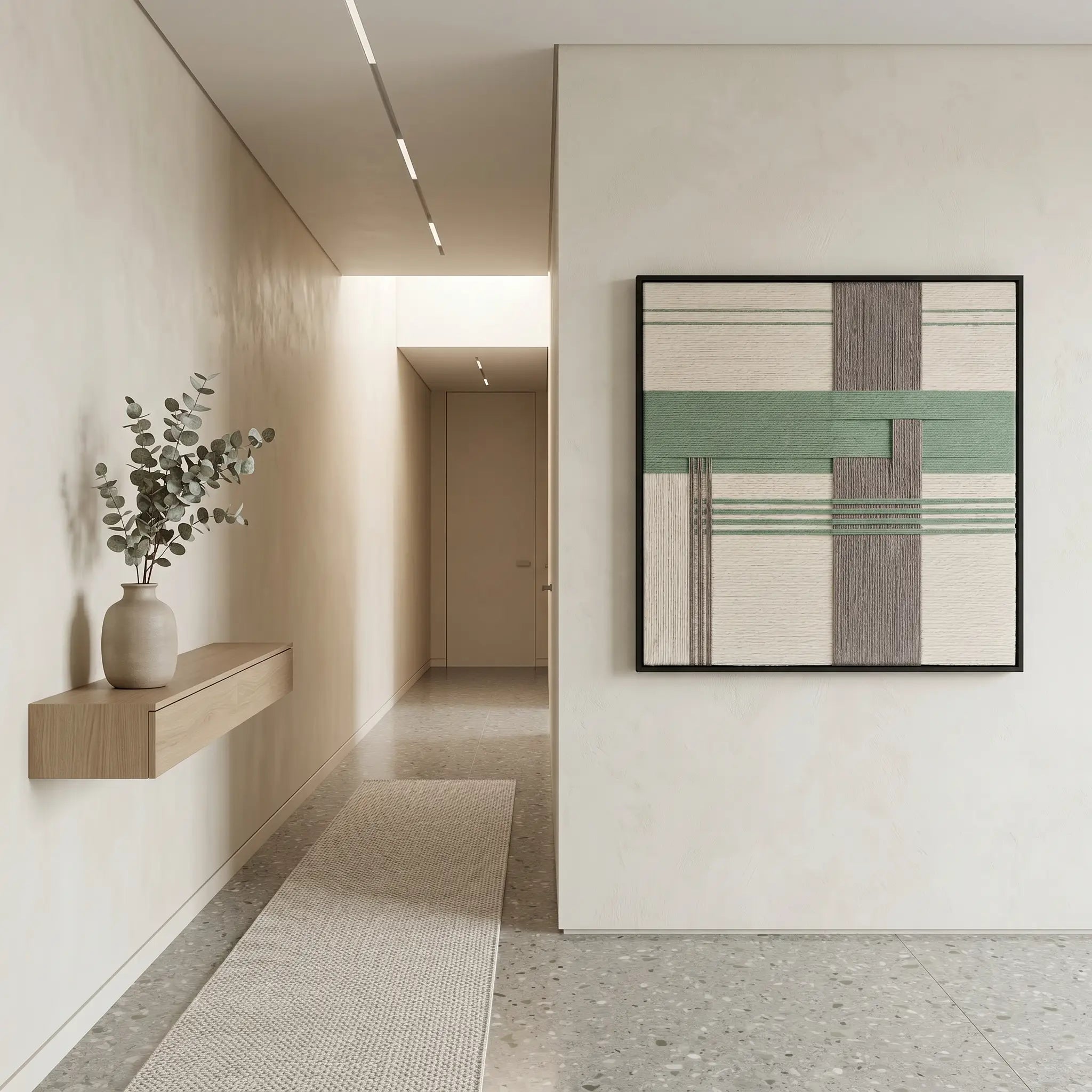 Square pastel green and grey textured wool art creating a serene focal point in a bright minimalist hallway.
