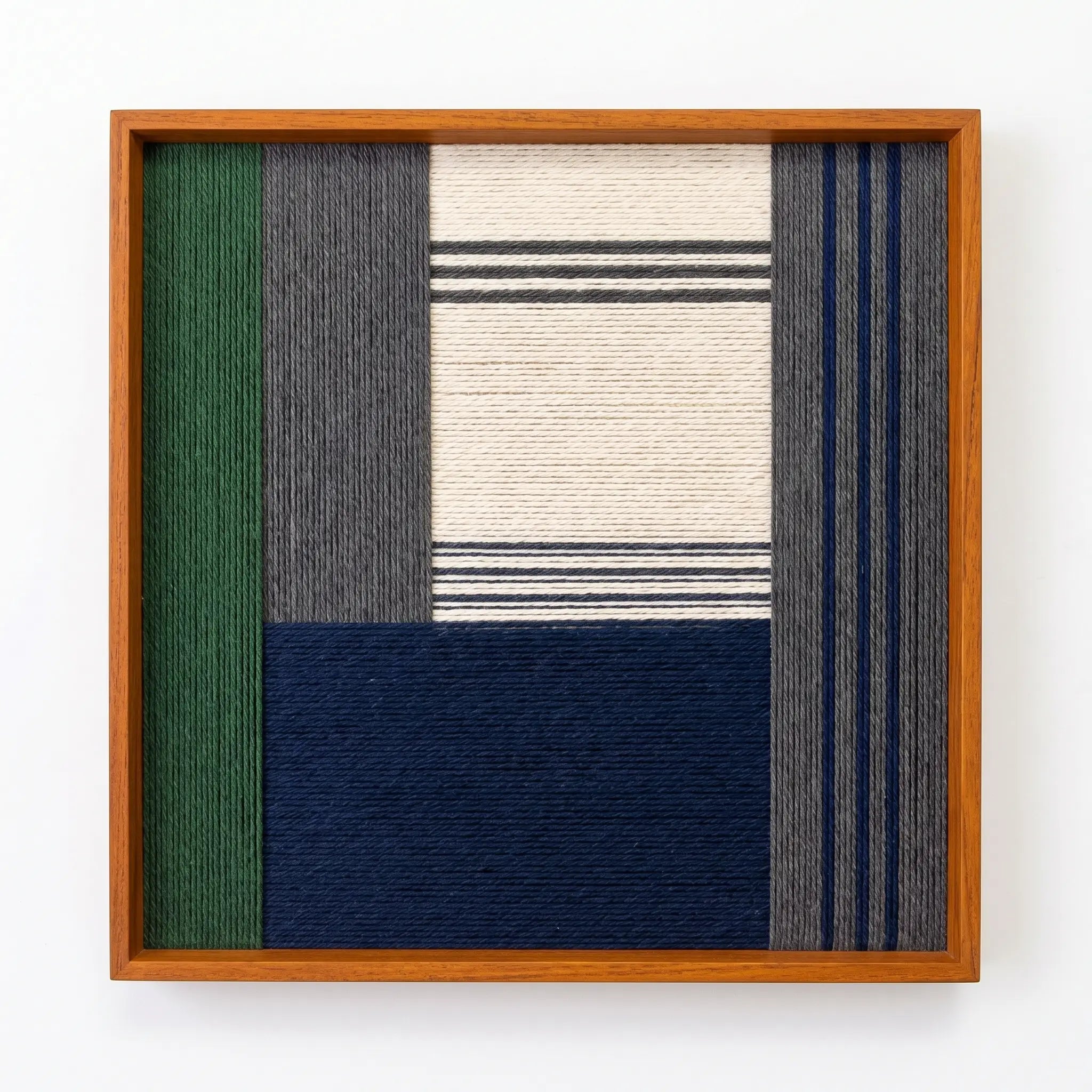 Professional studio shot of the Needle and Ink hand-woven wool wall art in an oak frame against a clean white background.