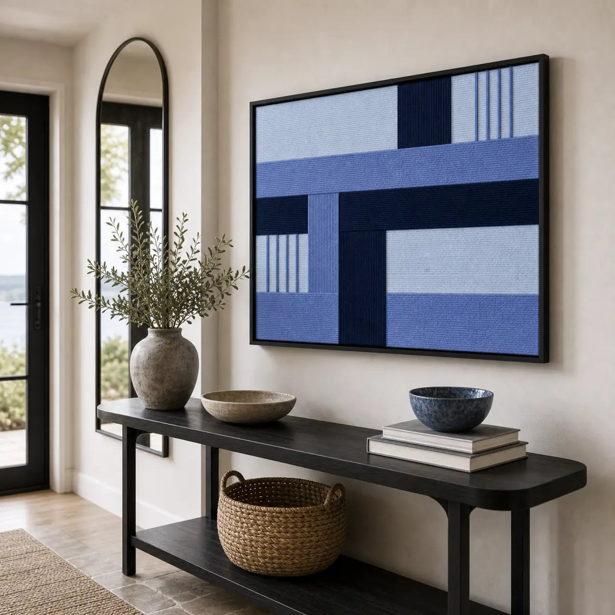 Striking Nordic Tide framed wall art styled in a bright entryway next to a mirror, hanging above a sleek black console table.