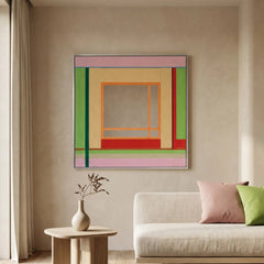 Large hand-woven wool wall art with green and pink geometric patterns displayed above a modern cream sofa and stone coffee table.