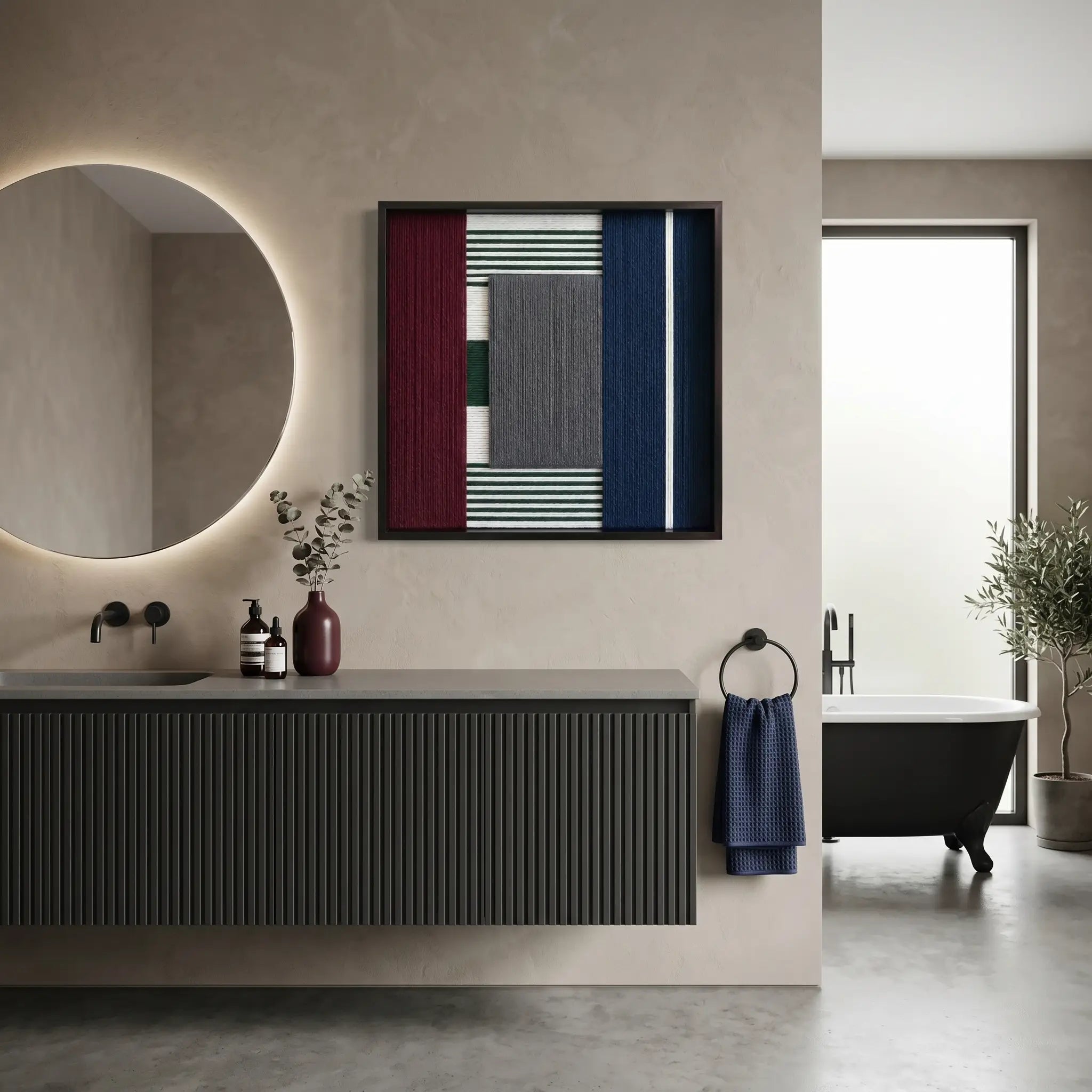Modern textured wool wall art displayed in a luxury bathroom above a dark floating vanity with a backlit circular mirror.