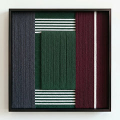 Frontal studio shot of the textured fiber wall art variant featuring a central forest green wool block with striped accents.