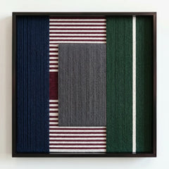 Professional studio shot of the hand-wrapped yarn wall art with a textured grey center and burgundy side panels.