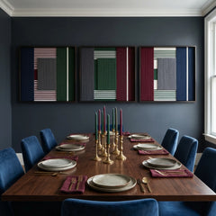 The Overture of Dusk & Dawn triptych wall art displayed above a long dark wood dining table, creating a sophisticated focal point in a moody, elegant dining room.