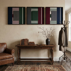Sleek Overture of Dusk & Dawn textile wall art triptych hanging above a classic wooden entryway console table with decor, providing a warm, polished aesthetic.