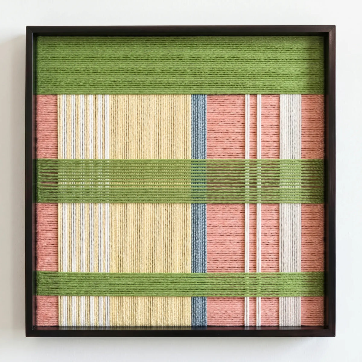 Frontal studio shot of the Pastoral Lullaby hand-woven wool wall art in a square black frame against a clean white background.
