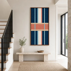 Bright hallway setting showcasing the vertical framed wool wall art hanging against a neutral wall beside a staircase and console table with natural light.