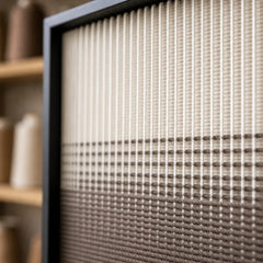 Detailed macro close-up of the Quiet Thread hand-woven wool tapestry highlighting the beautiful textured gradient yarn.