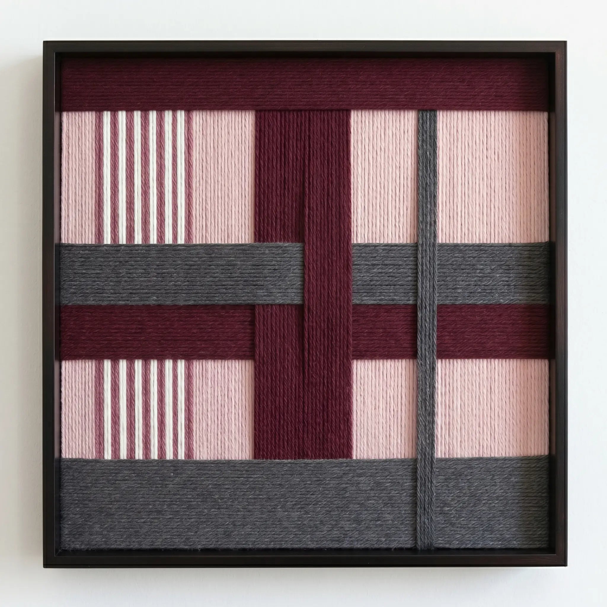Professional studio shot of the Rose Coordinates hand-woven wool wall art in a square black frame against a clean white background.