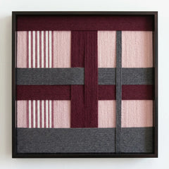 Professional studio shot of the Rose Coordinates hand-woven wool wall art in a square black frame against a clean white background.