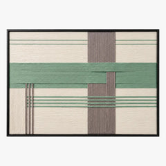 Frontal studio shot of the Sage Crossing hand-woven wool wall art featuring green and grey geometric blocks in a black frame.