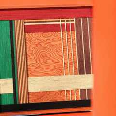 Close-up of Saint Christmas wool yarn art revealing tight looped stitch detail and crisp edges between red and green panels
