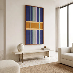Contemporary lounge area styling featuring the framed textile art mounted on a neutral wall above a long wooden bench.