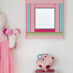 Secret Crush wall art mounted in a pastel bedroom setting next to a teddy bear and lamp, emphasizing its playful color-block design.
