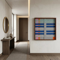 Square blue and grey textured wool art creating a vibrant focal point at the end of a long minimalist hallway.