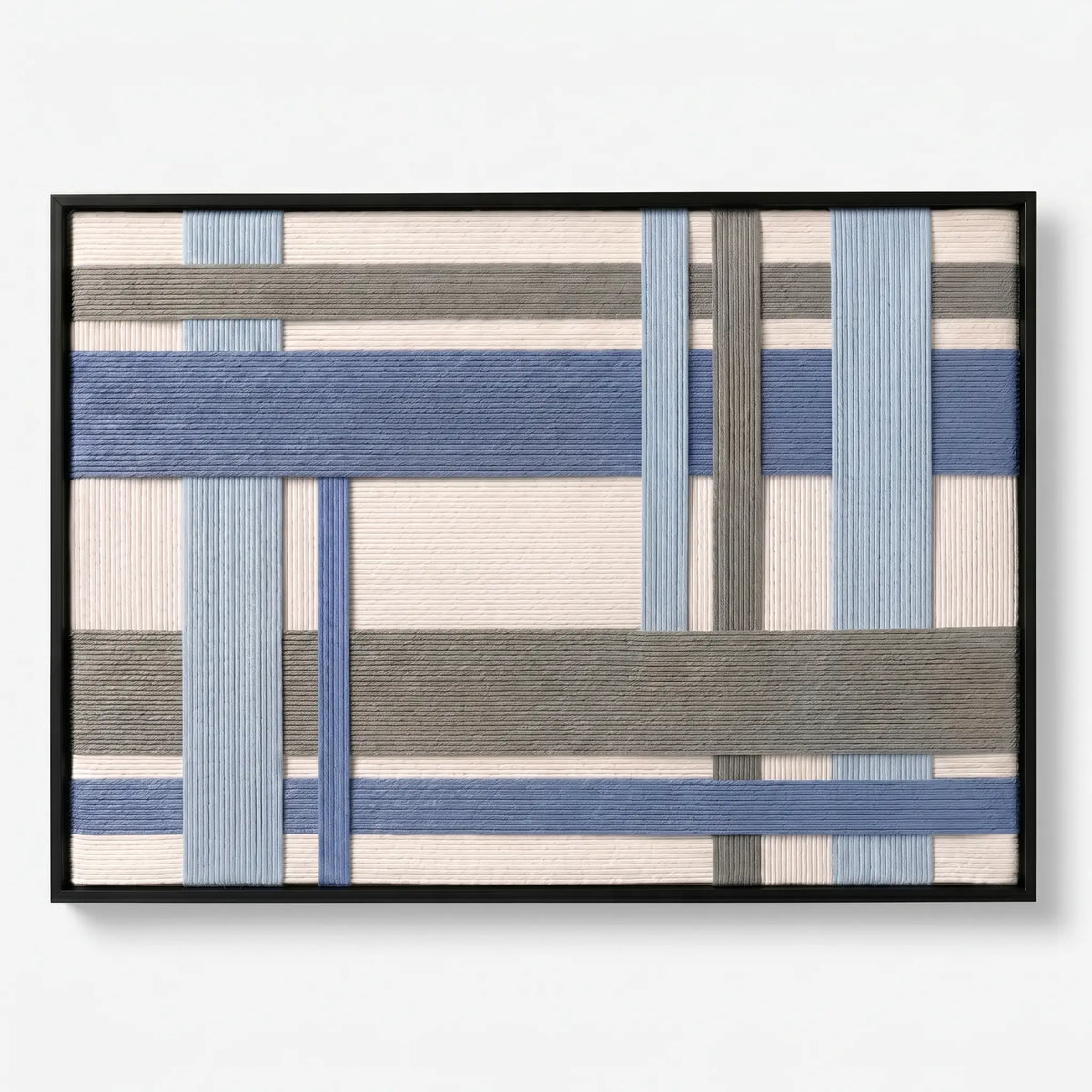 Frontal studio shot of the Slate Harbor hand-woven wool wall art featuring blue and grey geometric patterns in a black frame.