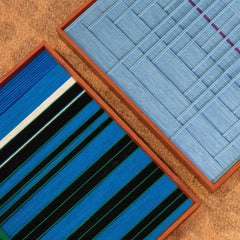 Close-up of Summer Night’s Serenity wool yarn showing tight looped texture and seamless transitions between navy, forest green, and mint accent fibers
