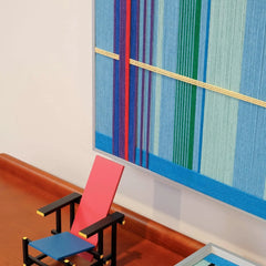 Summer Story wall art propped on a laptop, highlighting its compact square format and framed design
