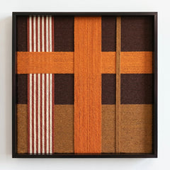 Frontal studio shot of the Sunlit Symphony wool wall art featuring a bold orange cross pattern and striped beige accents in a black frame.