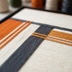 An angled close-up view highlighting the high-value texture of the hand-wrapped wool yarn and intricate geometric textile patterns.