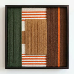 Frontal view of the textured fiber wall art featuring vertical forest green and brown wool blocks with orange striped accents.