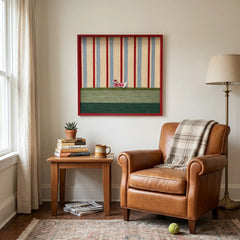 Framed striped textile wall art displayed in a cozy reading corner above a classic brown leather armchair and small side table.