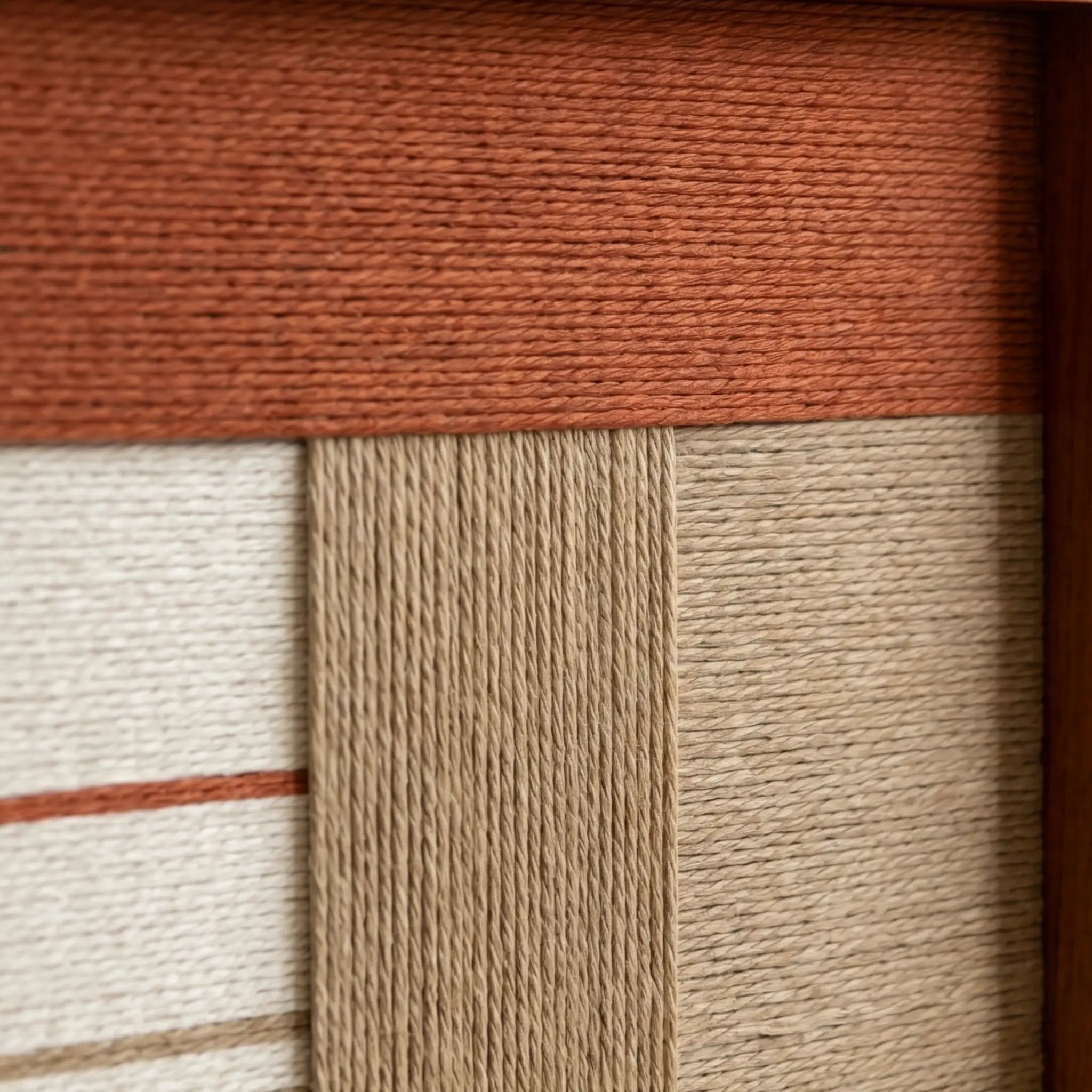 Detailed macro close-up of the Terracotta Haven hand-woven textile art highlighting the textured terracotta, beige, and cream yarn blocks.