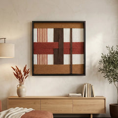 Large square hand-woven wool wall art in terracotta and espresso tones hanging above a light oak sideboard in a minimalist living room.