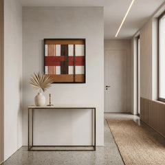 Vertical perspective of the terracotta fiber art hanging above a slim metal console table in a bright modern hallway.