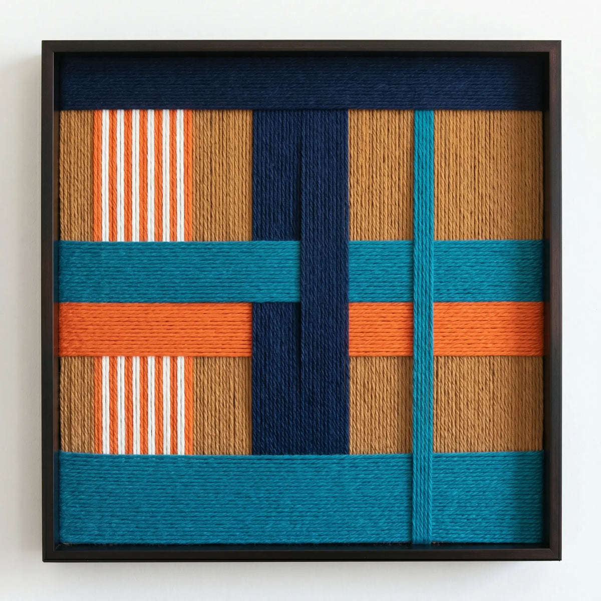 Professional studio shot of the Tropical Glow hand-woven wool wall art in a black frame against a clean white background.