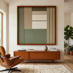 Striking square hand-woven wool tapestry positioned perfectly above a low wooden credenza next to a classic mid-century leather lounge chair in a sunlit room.