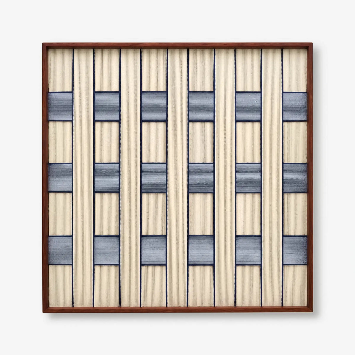 Professional studio shot of the Winter Stationery hand-woven wool wall art in a dark wood frame against a white background.