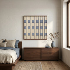 Blue and beige hand-woven fiber art styled in a serene bedroom above a walnut dresser with neutral linens.