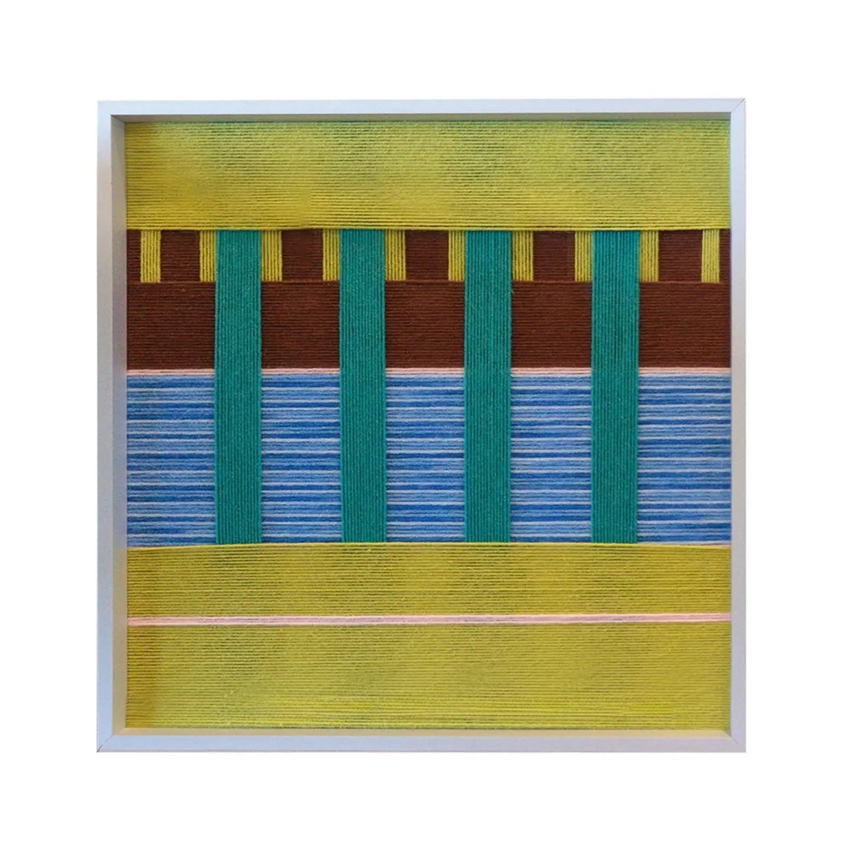 Frontal studio shot of the Woodland Mirror hand-woven textile wall art featuring green, blue, and brown color-blocking in a white frame against a clean white background.